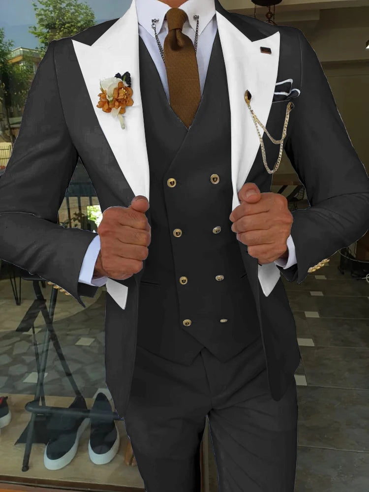Black tuxedo with white lapels, gold buttons, boutonniere, and chain accessories for formal events