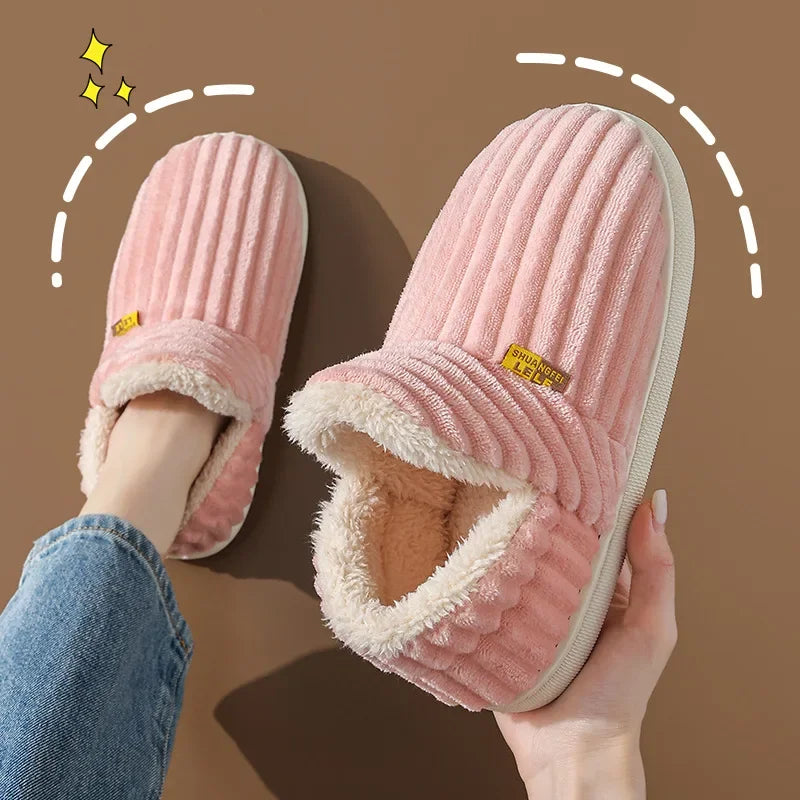 Pink plush ribbed slippers with cozy fleece lining, held and worn, warm loungewear footwear
