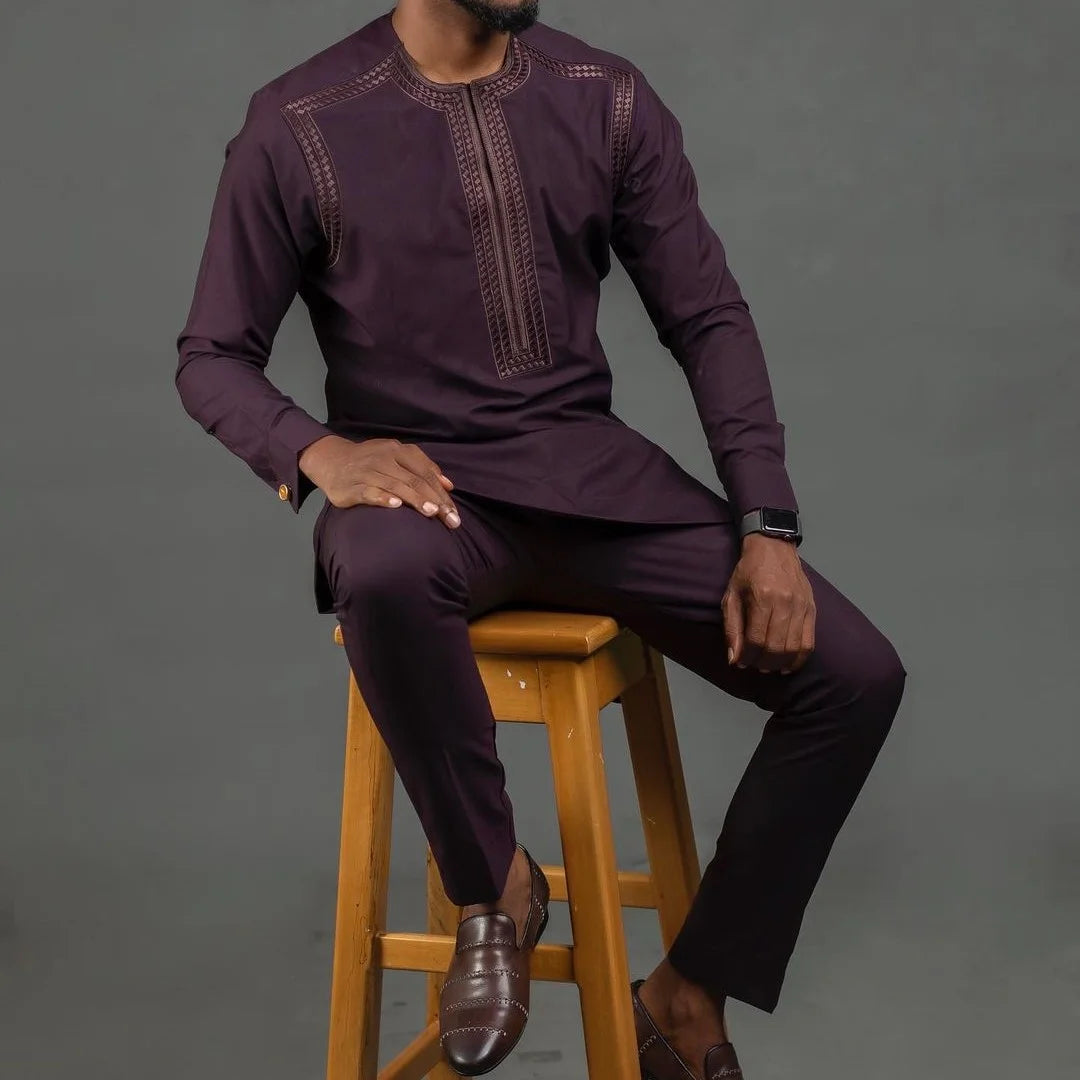 Concierge Tiers visuals with a man in dark purple traditional loungewear sitting on a wooden stool
