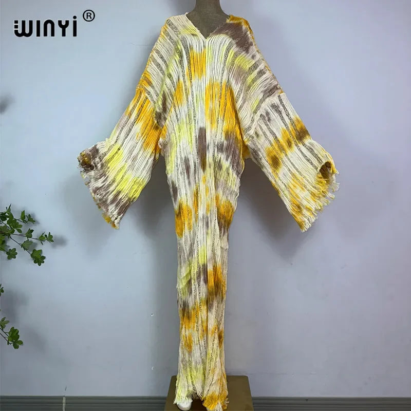Loose pleated kimono robe with yellow and brown tie-dye pattern on mannequin