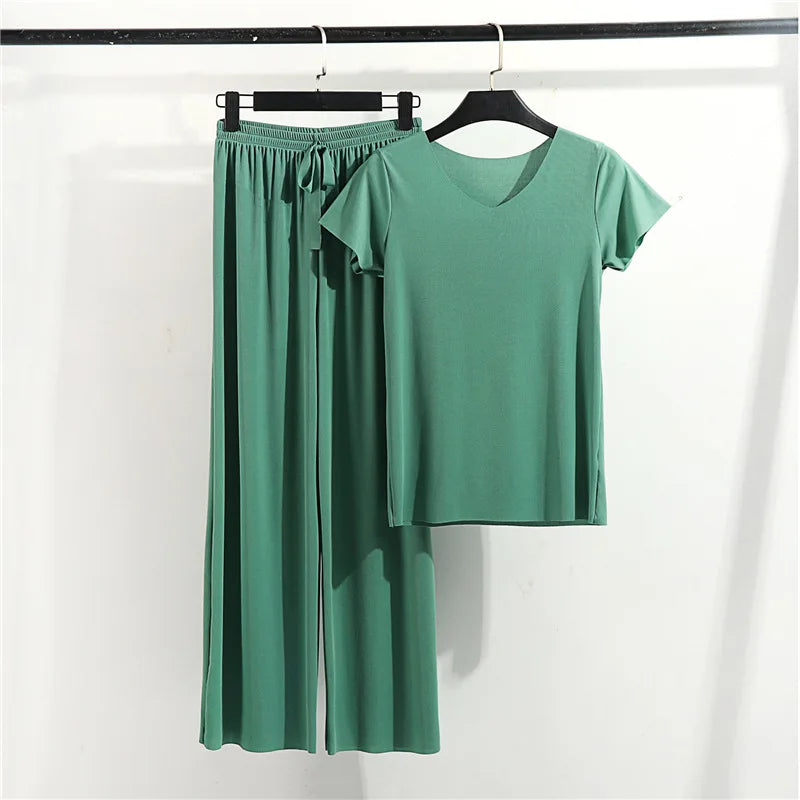 Green loungewear set with short sleeve top and wide-leg pants on hangers, cozy style