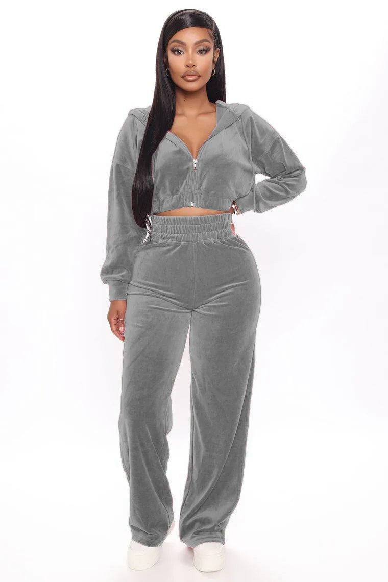 Woman modeling soft grey velour loungewear set with zip-up hoodie and wide-leg pants