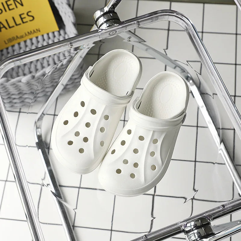 Concierge Tiers display with white breathable slip-on clogs on a tile background