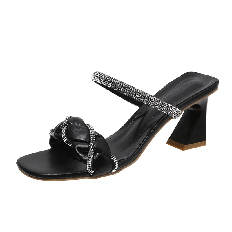 Black heeled sandal with rhinestone straps and braided front detail, displayed on white background