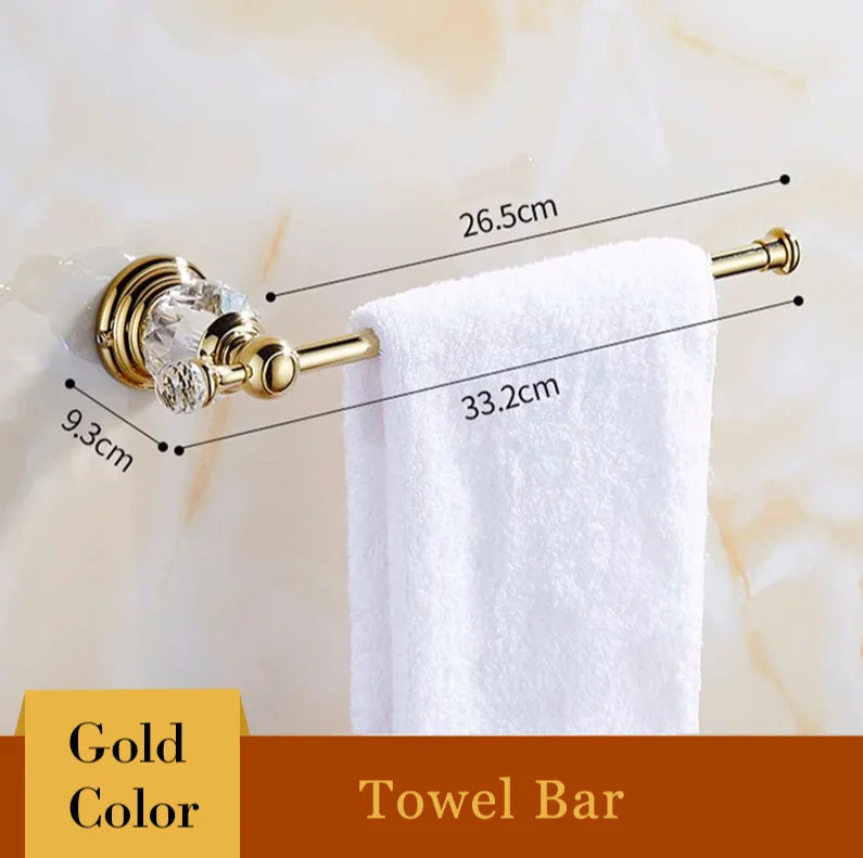 Gold towel bar with crystal accent, holding white towel, bathroom accessory with dimensions shown