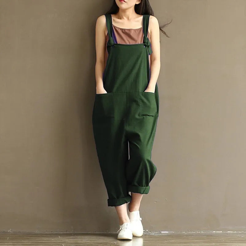 Green cotton overalls with rolled cuffs, paired with white slip-ons for cozy loungewear style