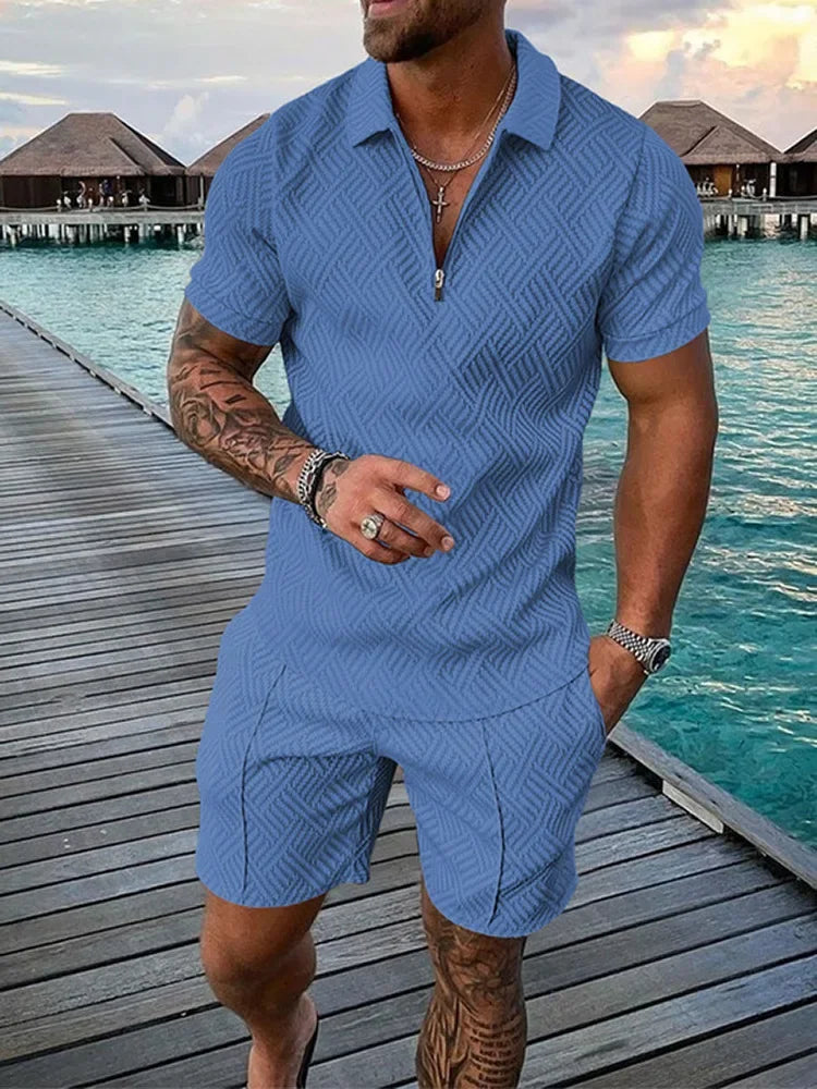 Concierge Tiers: Man wearing blue textured short-sleeve lounge set on boardwalk by water