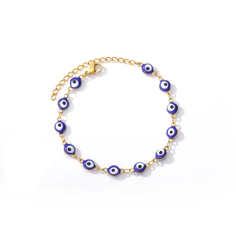 Gold chain bracelet with blue evil eye charms, shown on white background for concierge tier display