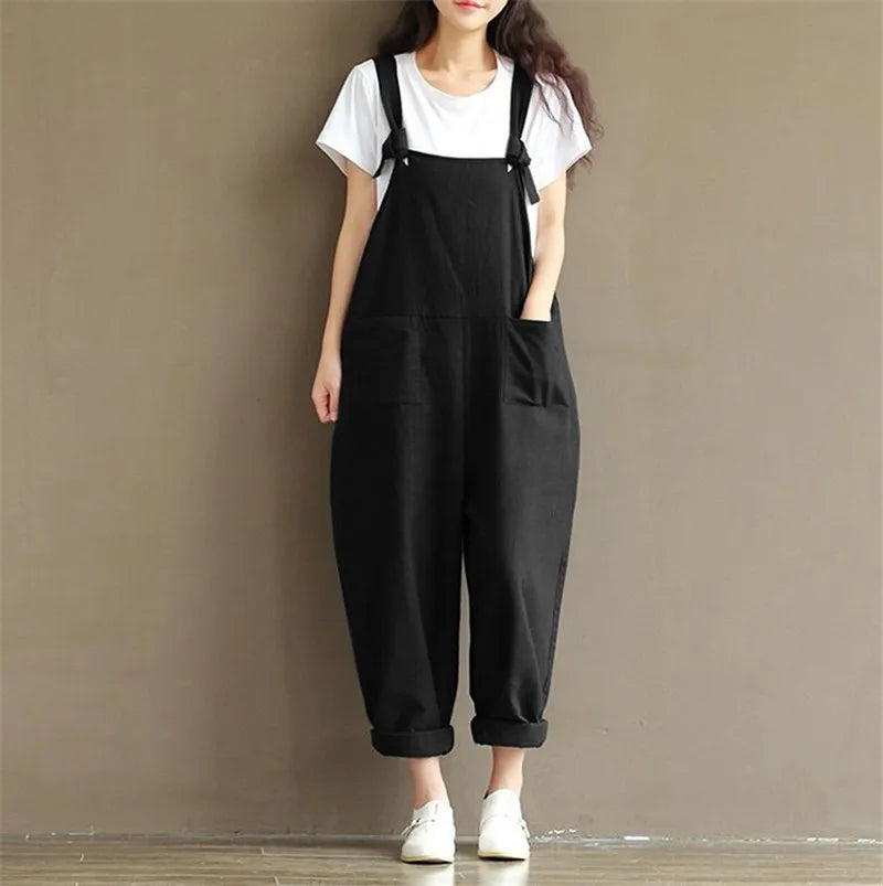 Black cotton overalls with adjustable straps, paired with white tee and sneakers for cozy loungewear