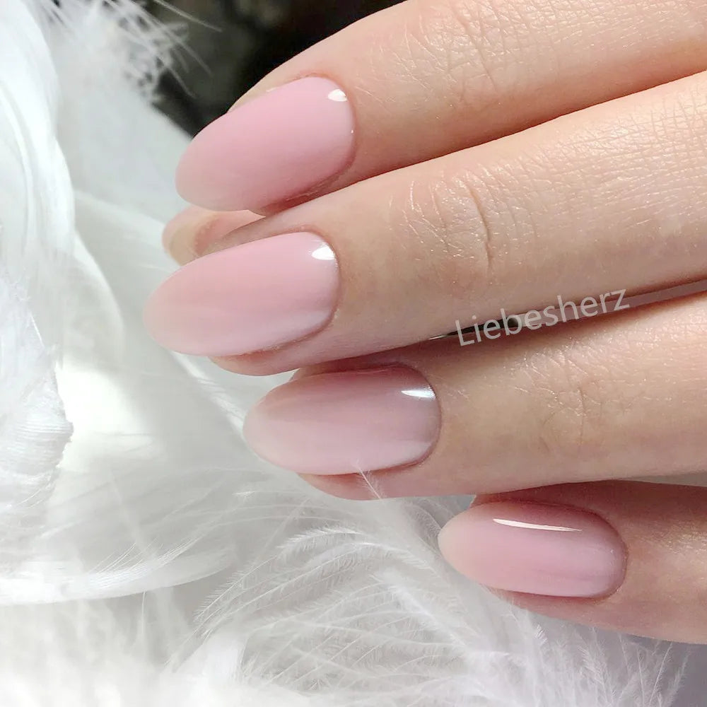 Concierge Tiers image showing manicured hand with glossy pale pink oval nails