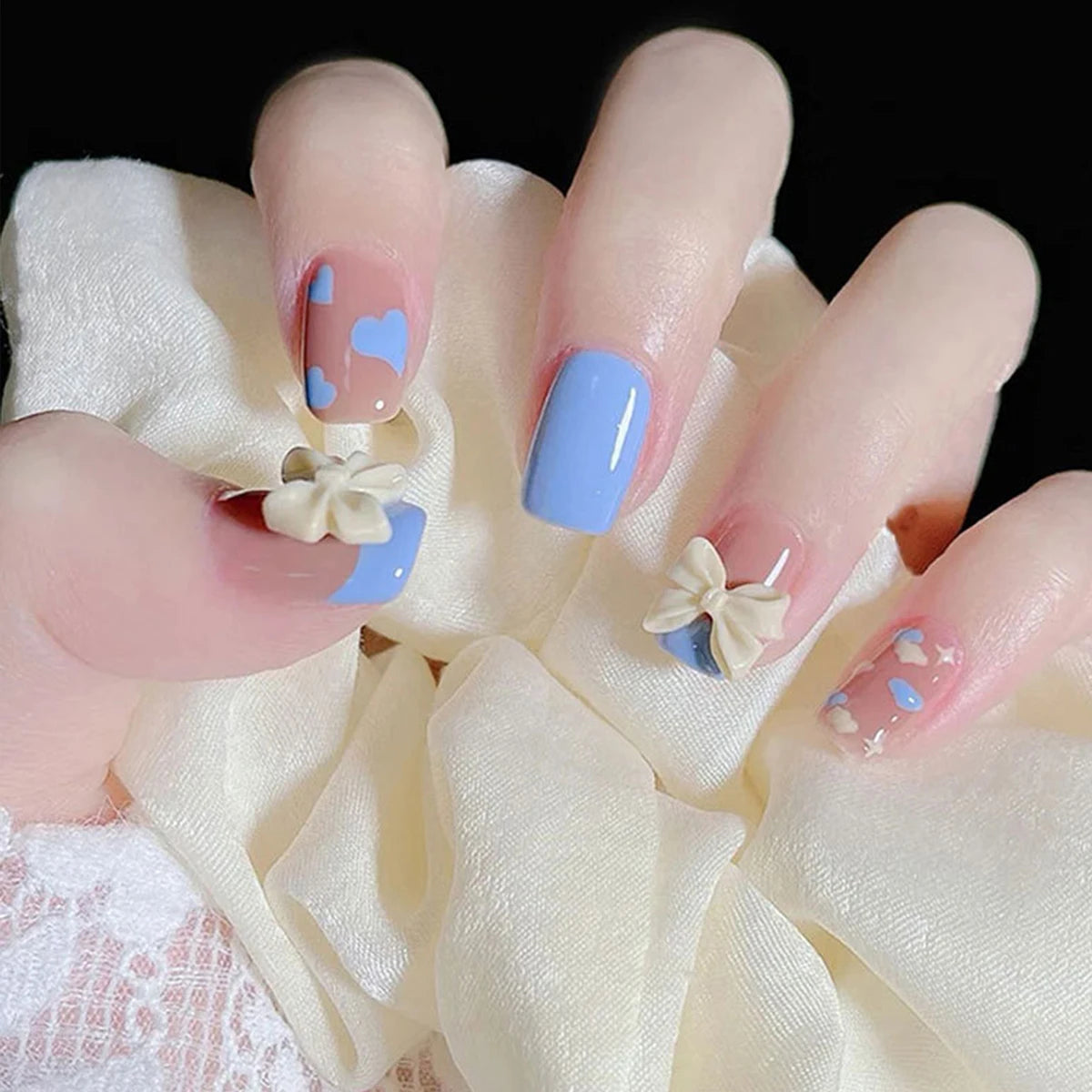 Concierge Tiers display with pastel blue nails, heart accents, pearl bows, feminine nail art