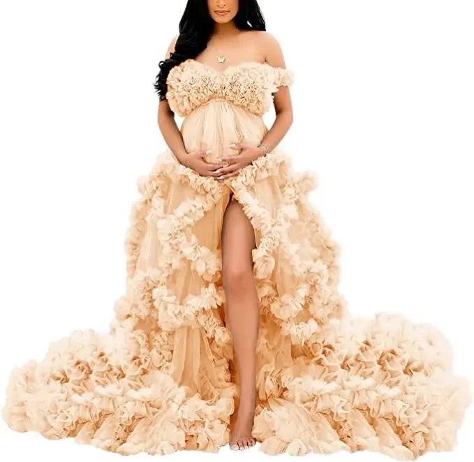 Elegant off-shoulder maternity gown with ruffled tiers, soft blush hue, perfect for maternity photoshoots